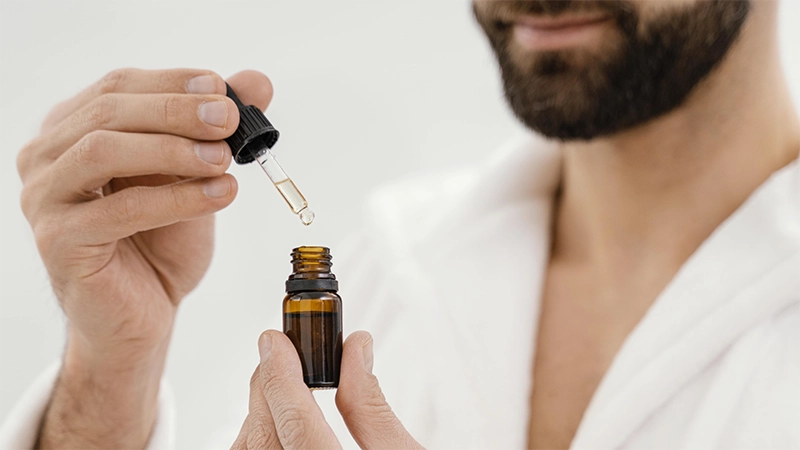 photo of a mature man holding essential oil