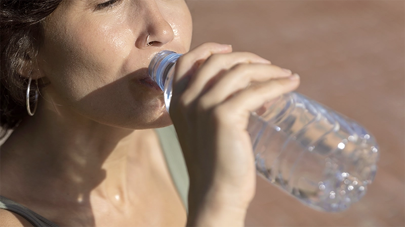 photo of a mature woman drinking water