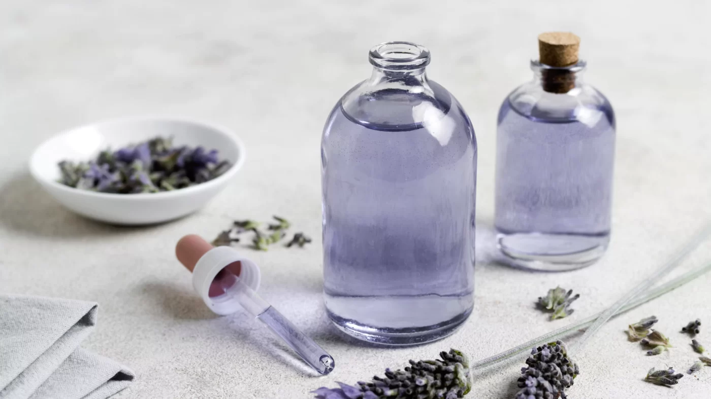 photo of lavender essential oils on a white table