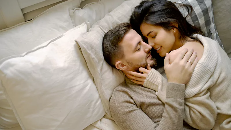 photo of a Romantic couple relaxing in bed