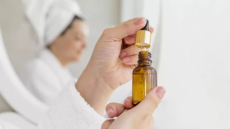 Close-up photo of a woman holding essential oils