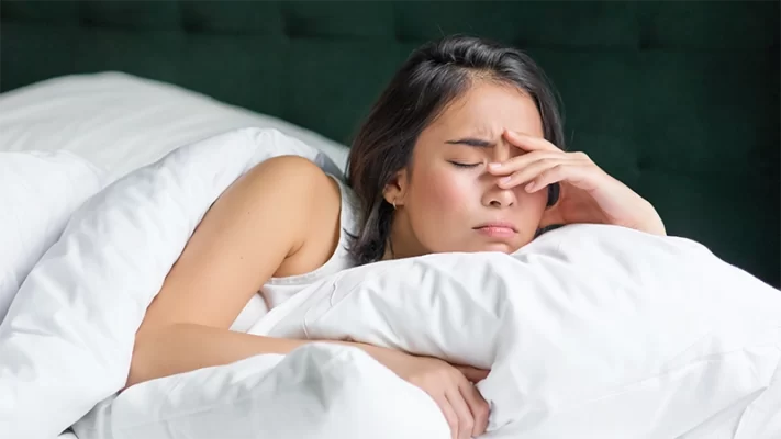 photo of a woman lying on the bed can't sleep