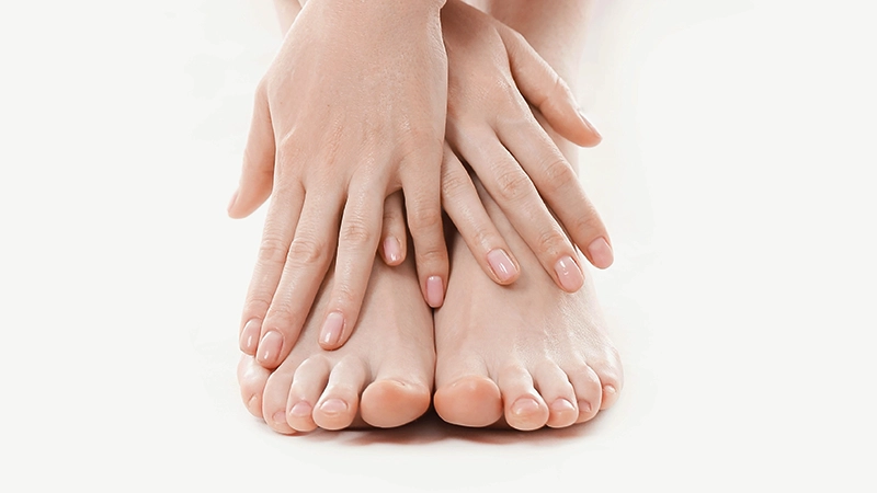 photo of a woman holding his feet