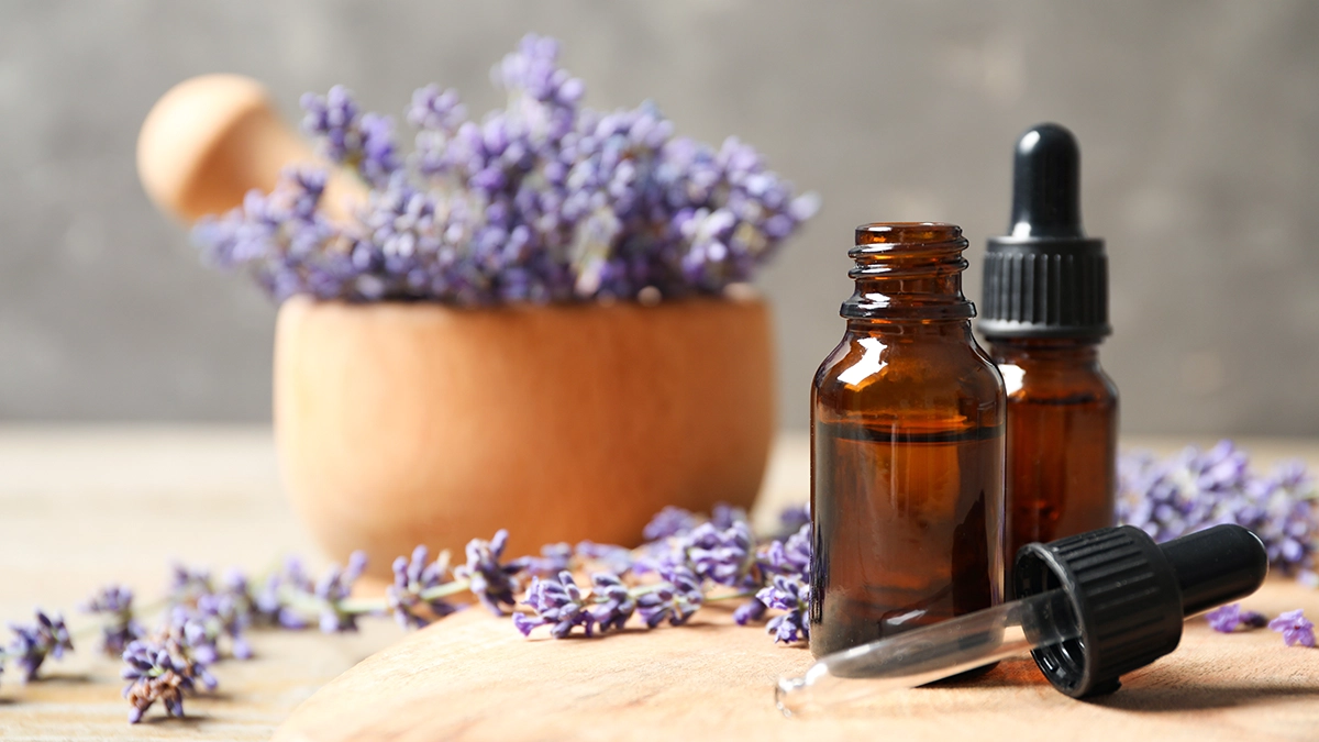 lavender flowers and a bottle of lavender essential oil for Bruised Skin